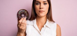 Woman holds up a donut